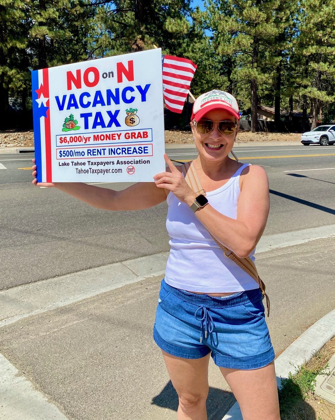 Dyna Boen out in the community holding a local ballot measure sign